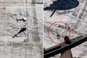 Harrowing moment helicopter hovers frighteningly close to cliff face to rescue fallen climber