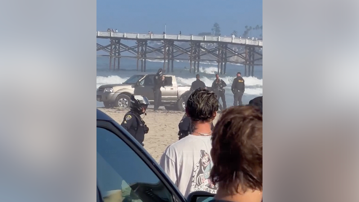 San Diego police surround a suspect on the sand after a police chase ended in Pacific Beach